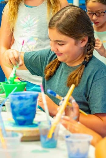 Older camper at ceramics