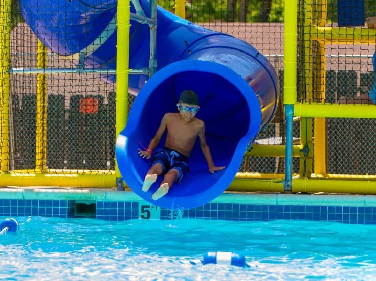 Boy going down waterslide